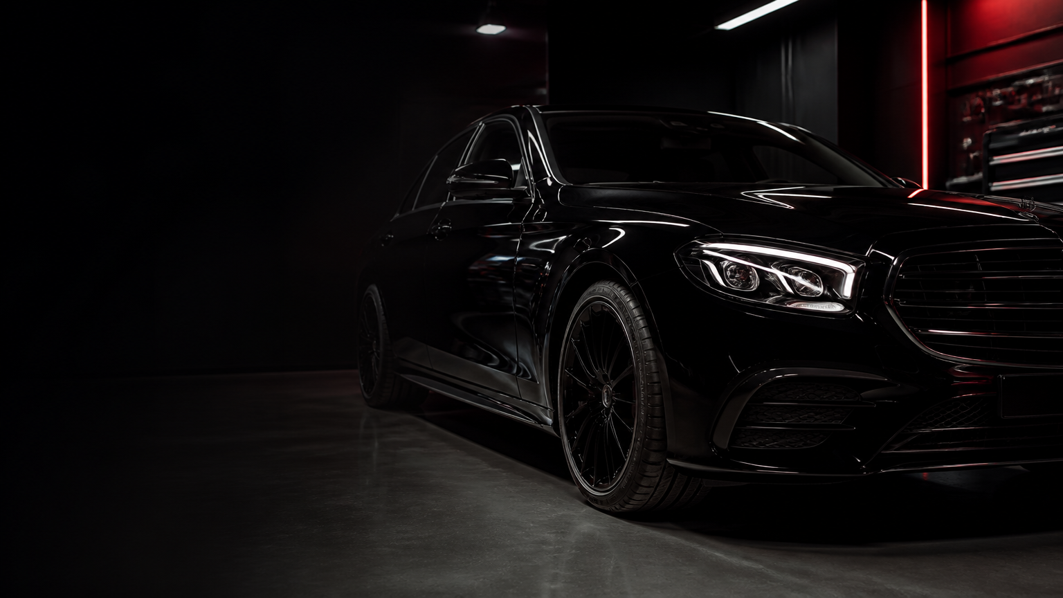 Refined black luxury sedan in a premium Burbank automotive workshop